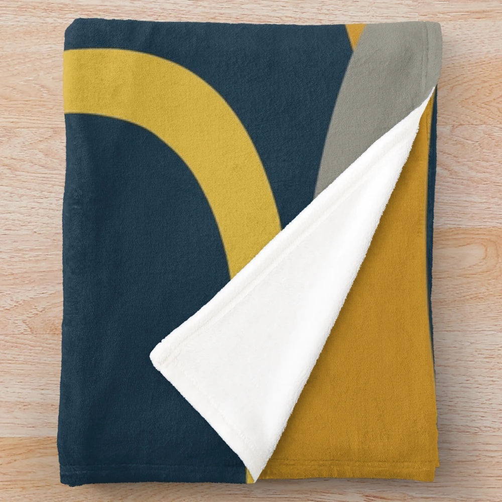 Retro abstract pattern plush blanket in navy, gray, and mustard colors