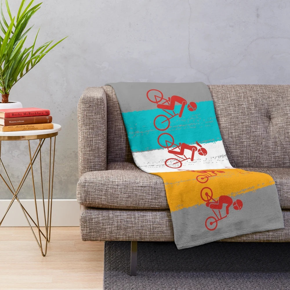 Retro-styled plush blanket featuring family cycling imagery