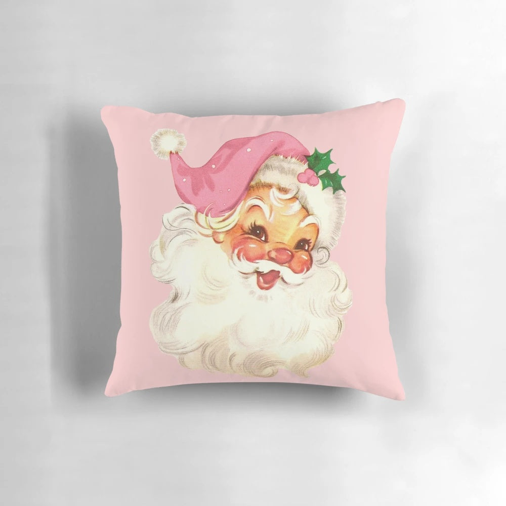 A plush, pink pillow featuring a vintage-style illustration of Santa Claus in a retro design.
