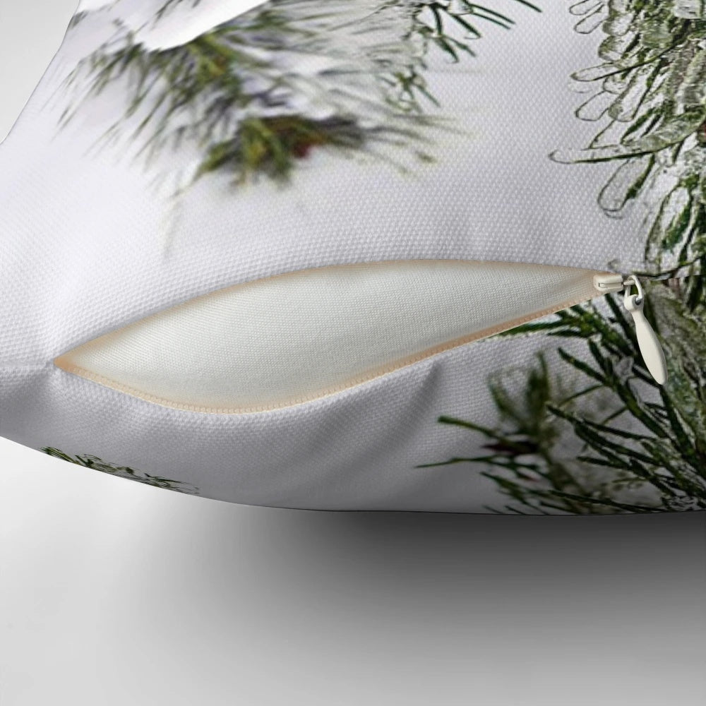 A decorative pillow featuring a beautiful robin bird perched on a snowy tree branch.