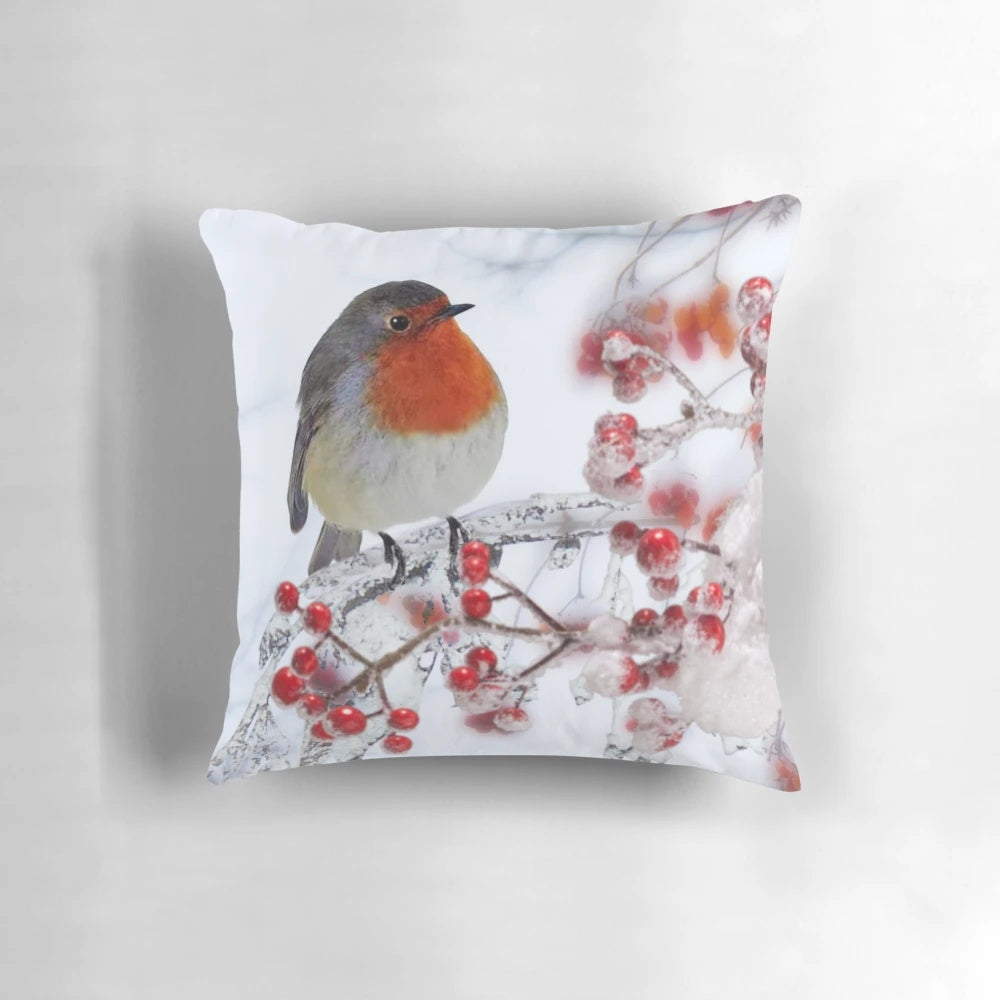 Festive pillow featuring a robin perched on snowy branches with red berries