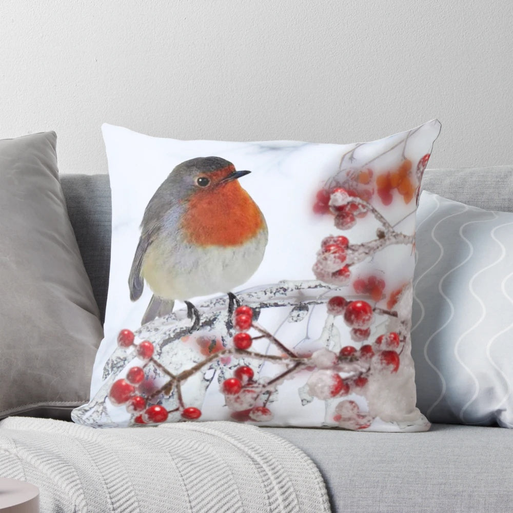 Festive pillow featuring a robin perched on snowy branches with red berries