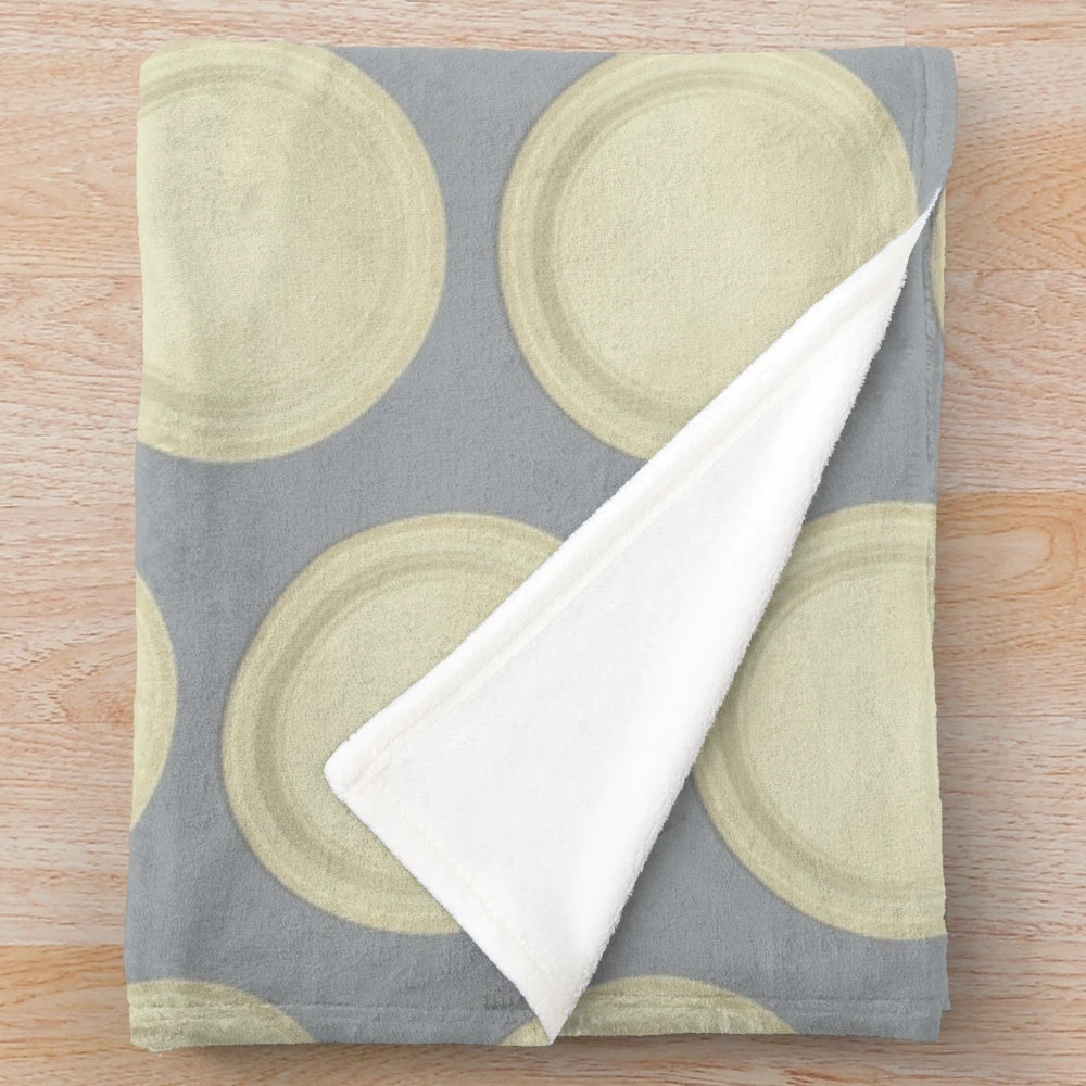 Soft, round plush blanket in a neutral color for cozy relaxation