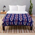 Plush blanket with "eat sleep rugby repeat" design and England rugby-inspired colors and elements