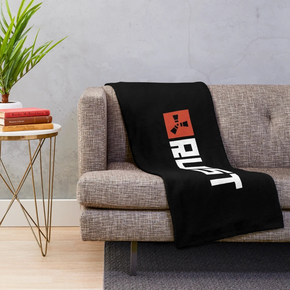 Rust game logo printed on a soft, plush blanket