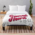 Soft and cuddly plush blanket featuring the Sacred Heart University logo