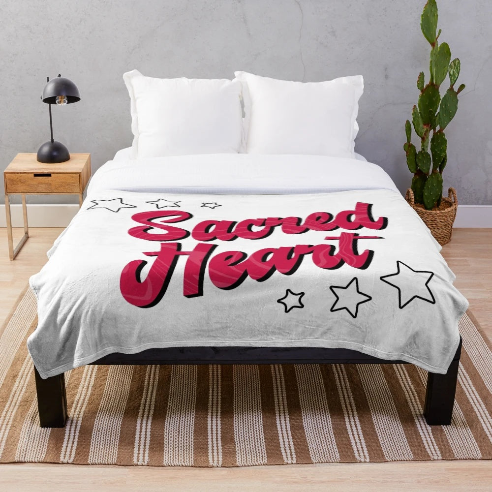 Soft and cuddly plush blanket featuring the Sacred Heart University logo
