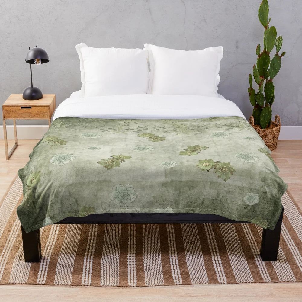 Sage green floral plush blanket with tonal flowers and nature-inspired botanical design