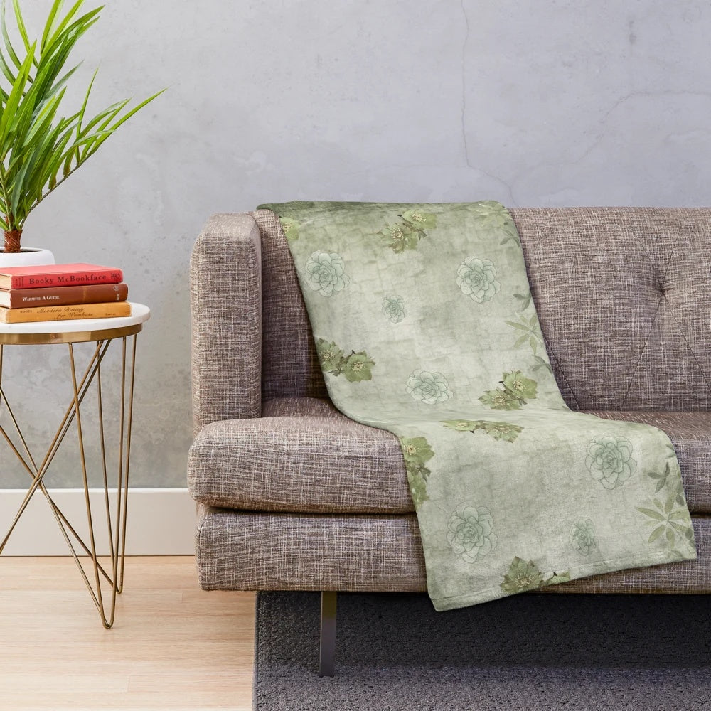 Sage green floral plush blanket with tonal flowers and nature-inspired botanical design