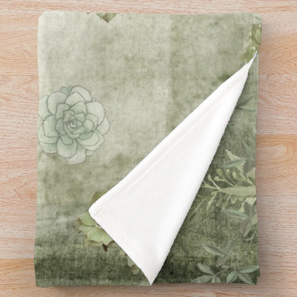 Sage green floral plush blanket with tonal flowers and nature-inspired botanical design