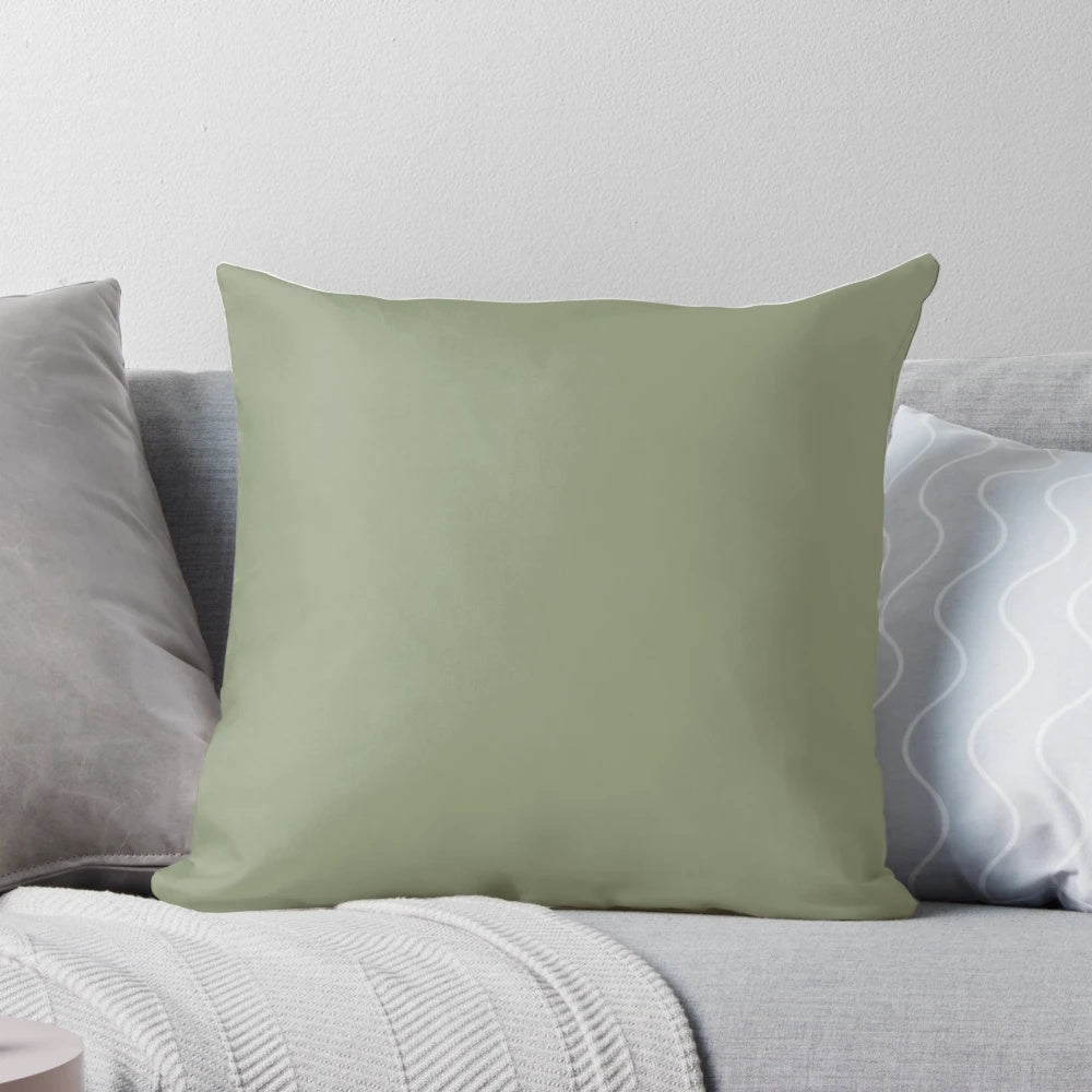 Sage green pillow with a soft, solid color design
