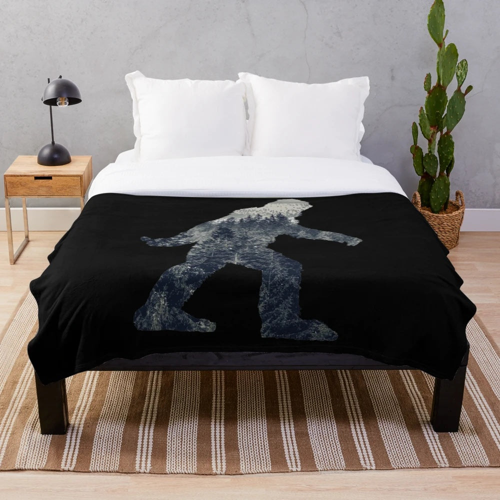 Sasquatch silhouette design on a cozy plush blanket