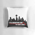 A plush pillow with the text 'Save Lives' on a plain background, inspired by the hit TV show Grey's Anatomy.