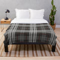 Cozy plush blanket with traditional Scottish tartan pattern in grey and white