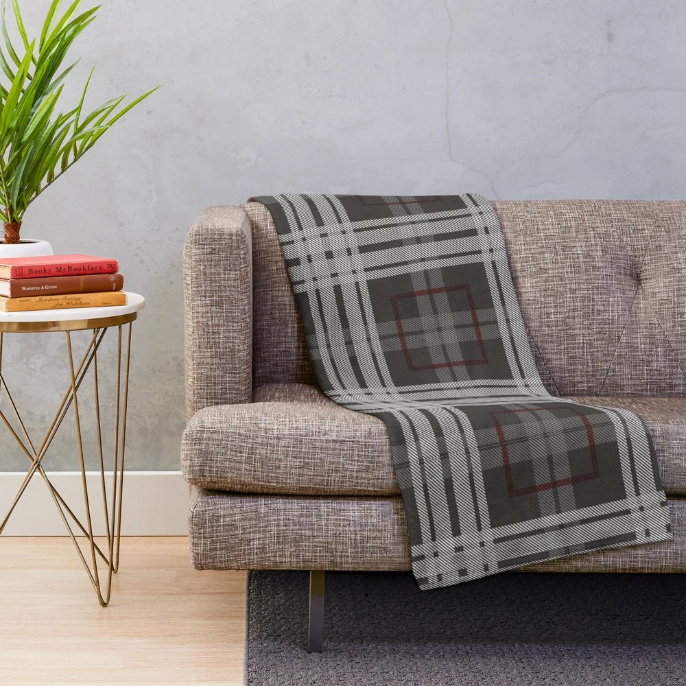 Cozy plush blanket with traditional Scottish tartan pattern in grey and white