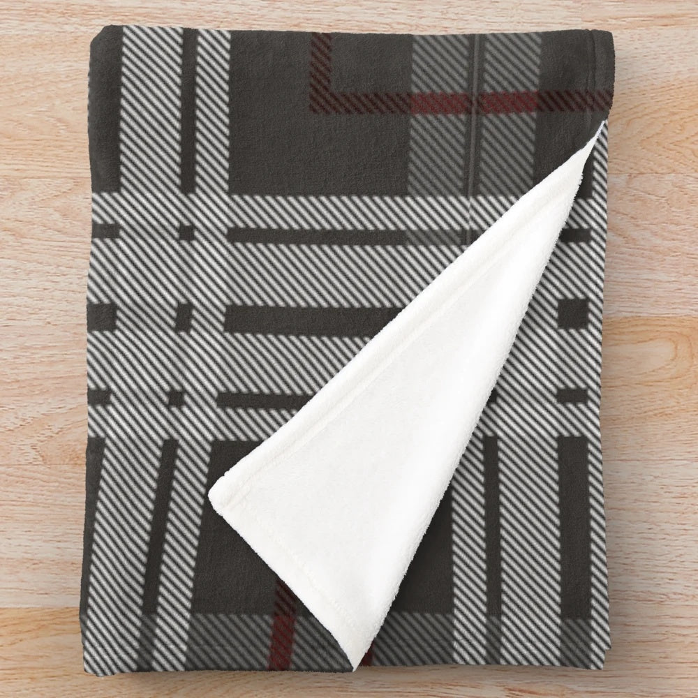Cozy plush blanket with traditional Scottish tartan pattern in grey and white