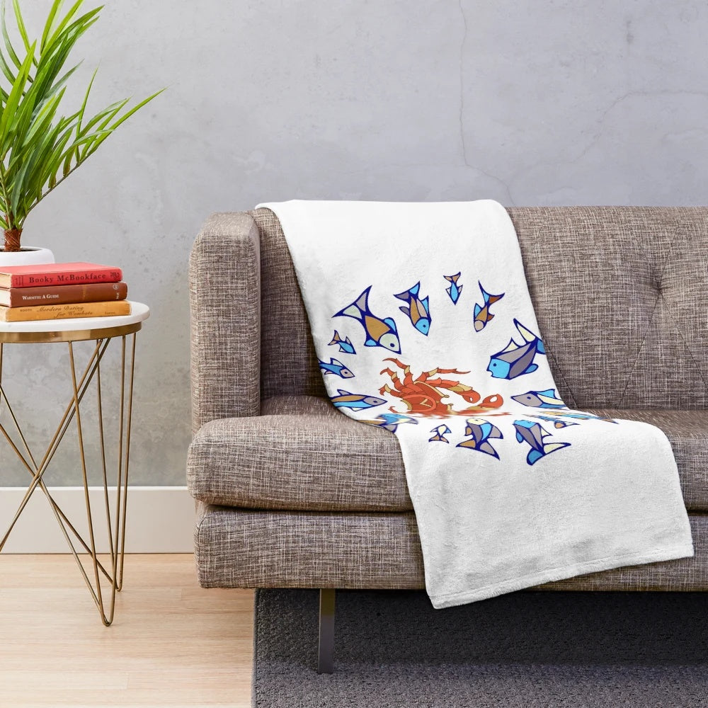 Plush blanket with blue fish, crabs, and other sea life designs