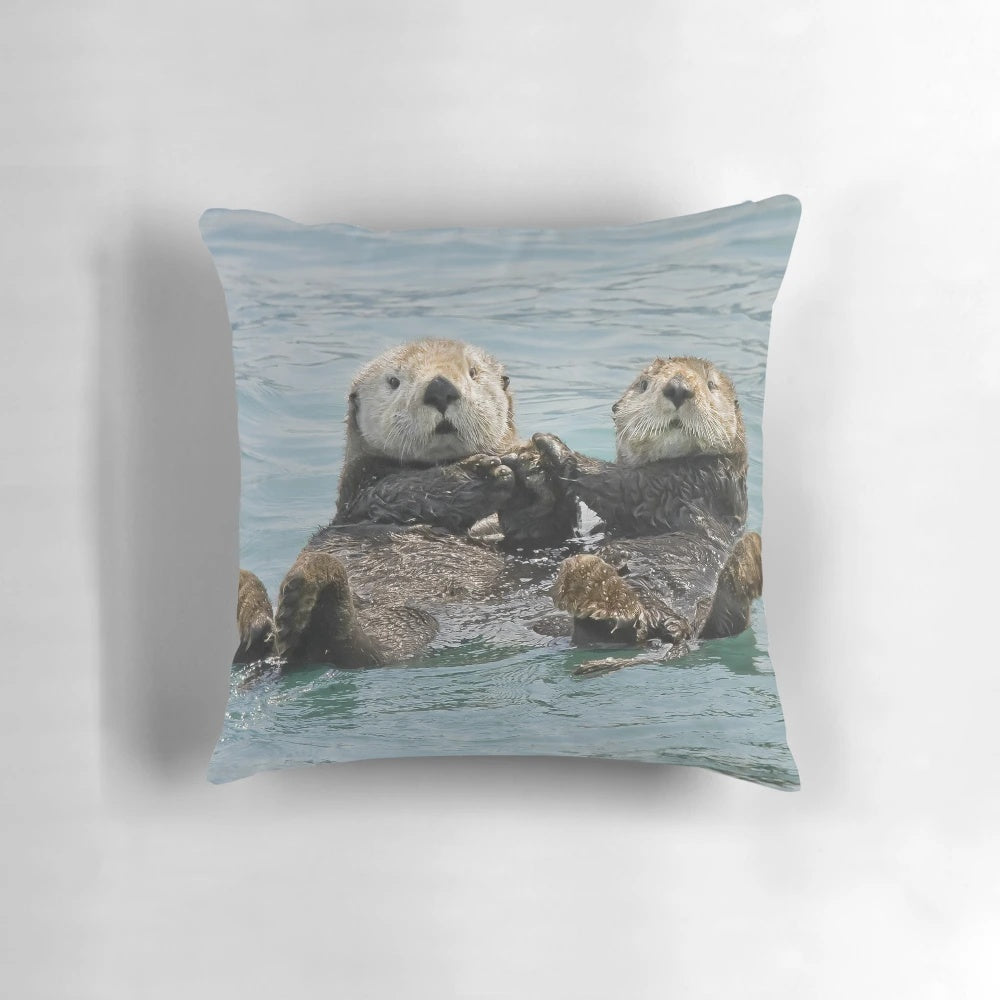 A soft, plush pillow featuring a high-quality image of a cuddly sea otter, perfect for sea otter and nature lovers.