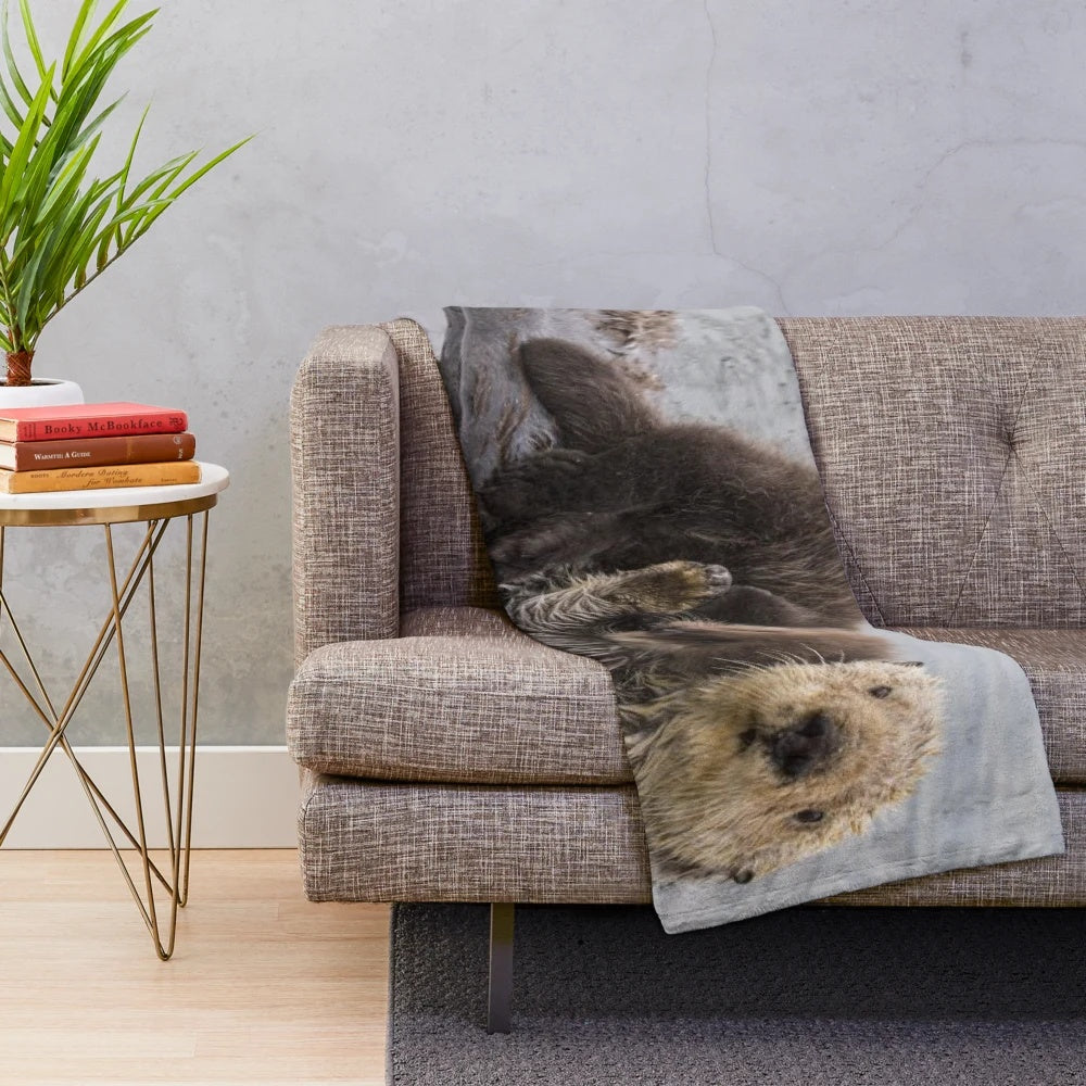 Soft plush blanket featuring a cute sea otter swimming with a baby otter
