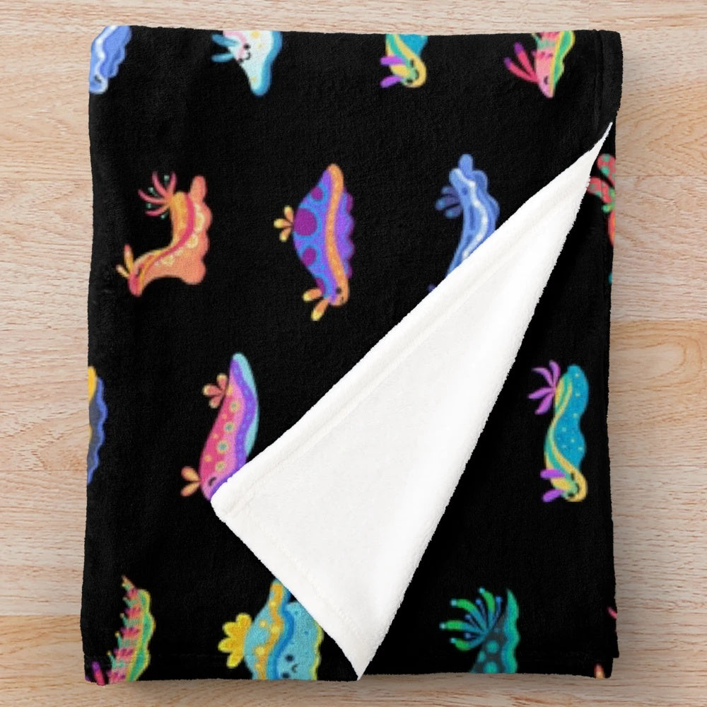 Black plush blanket featuring a detailed sea slug or nudibranch design