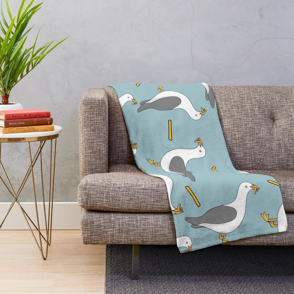 Soft plush blanket featuring a seagull and fish and chips design, perfect for summer beach-themed home decor