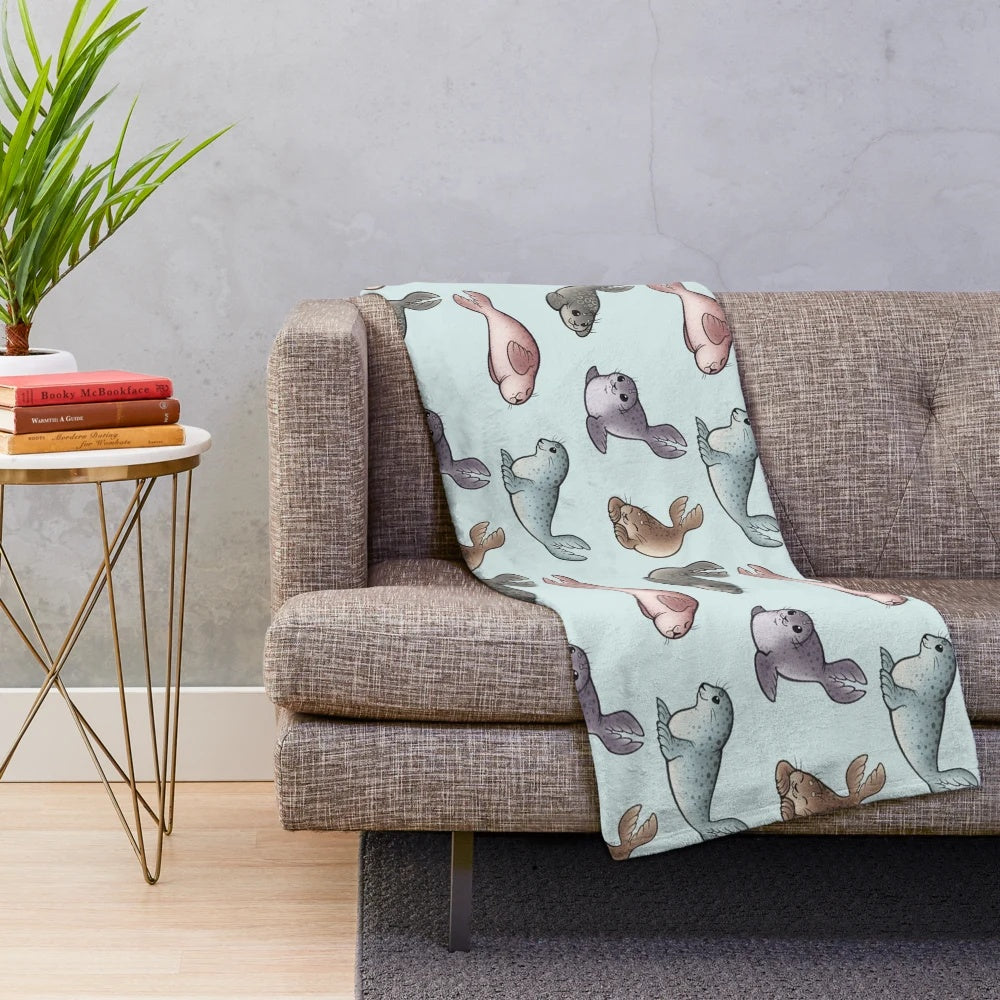 Plush blanket featuring cute and cuddly seals
