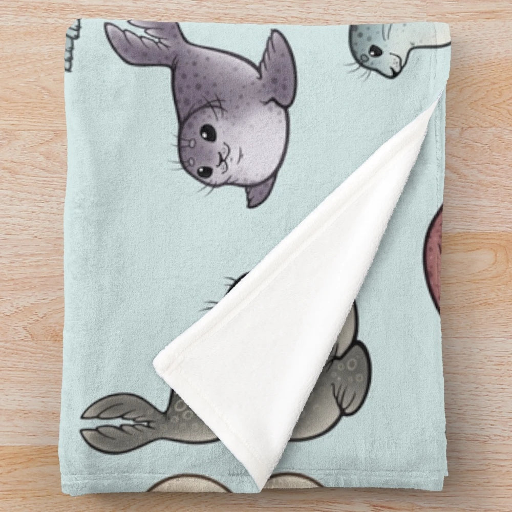Plush blanket featuring cute and cuddly seals