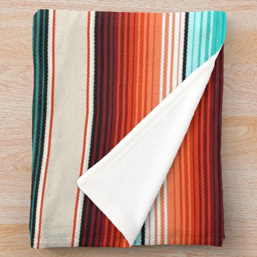 Navajo-inspired striped plush blanket in fall colors