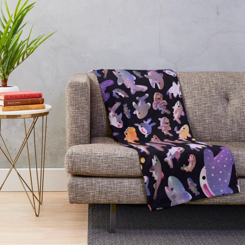 Soft and cuddly plush blanket featuring an array of shark species