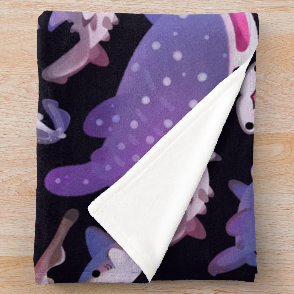 Soft and cuddly plush blanket featuring an array of shark species