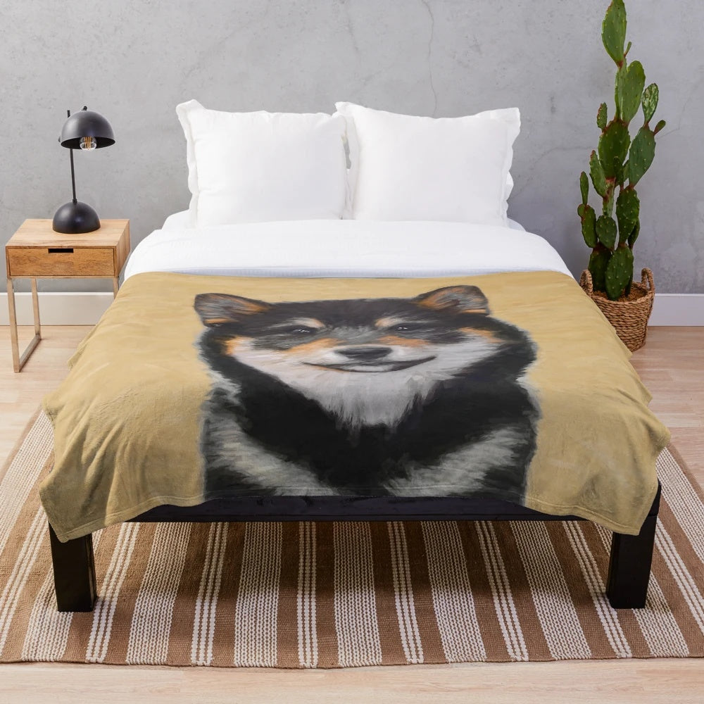 Shiba Inu dog portrait on a plush black and tan blanket