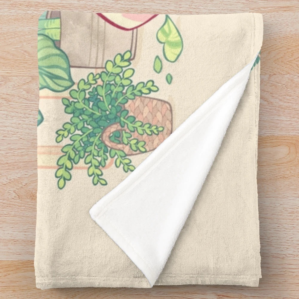 A soft, plush blanket featuring a green and pink shibakura plant design and a shiba dog