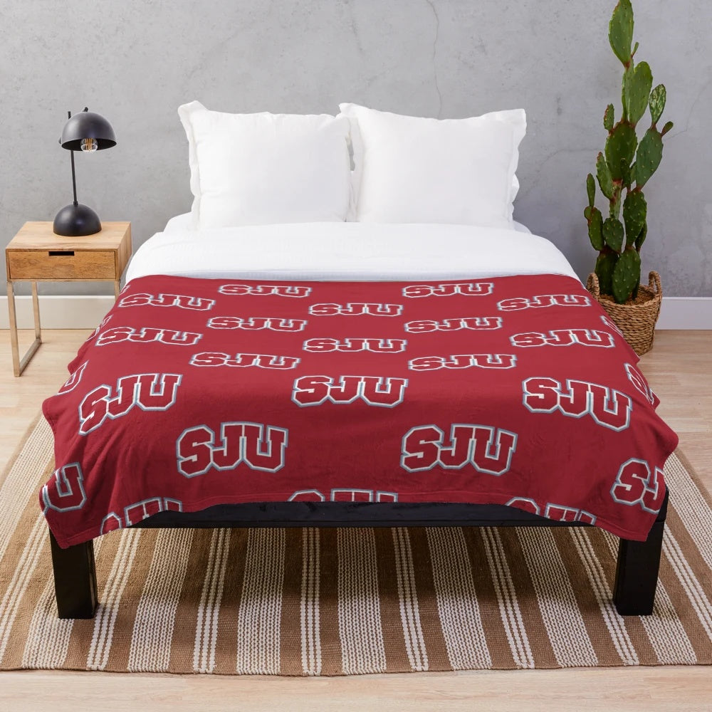 Soft, plush blanket featuring a rat design inspired by Saint Johns University.
