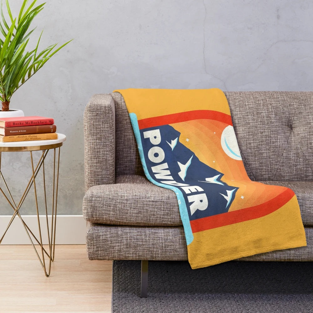 Ski-themed plush blanket with "Powder To The People" design