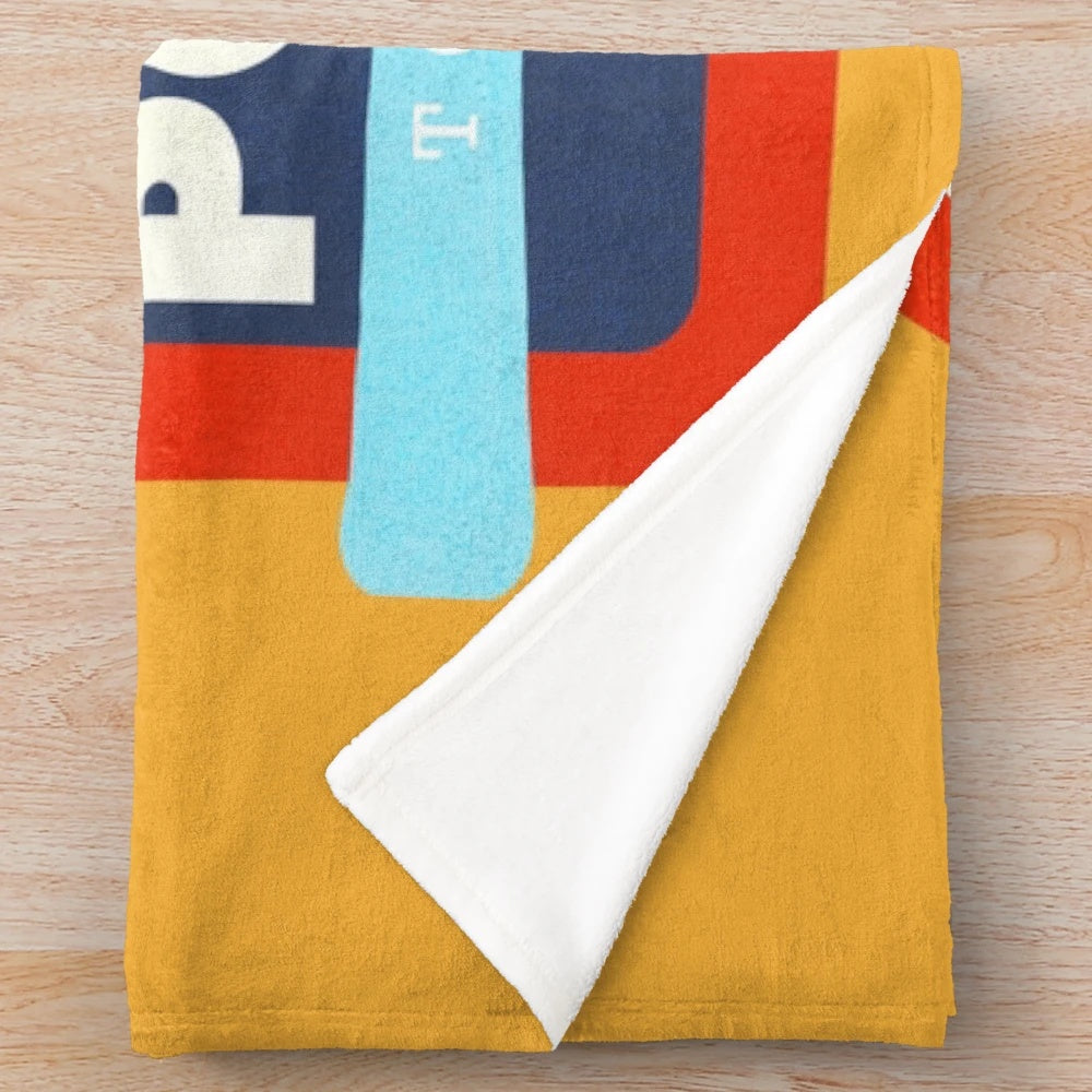 Ski-themed plush blanket with "Powder To The People" design