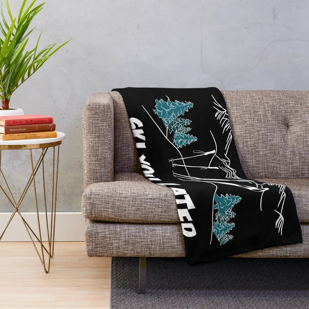 A cozy and plush blanket featuring a winter sports and snow scene design