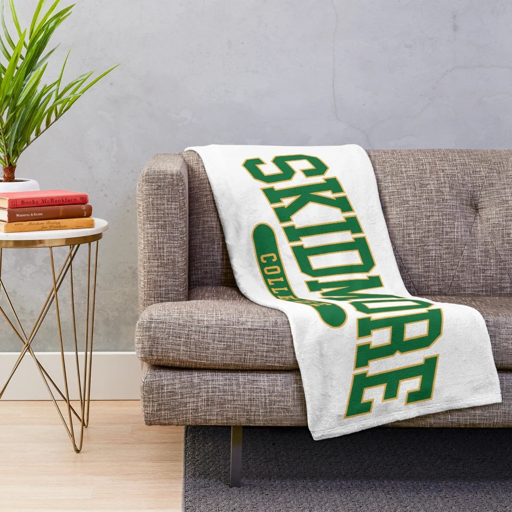 Soft and comfortable plush blanket featuring the Skidmore College logo and design