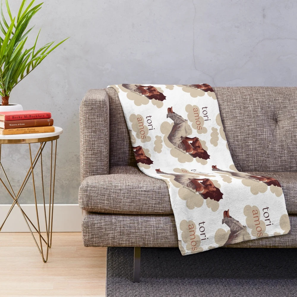 Plush blanket featuring a dreamy, cloud-like illustration inspired by singer-songwriter Tori Amos