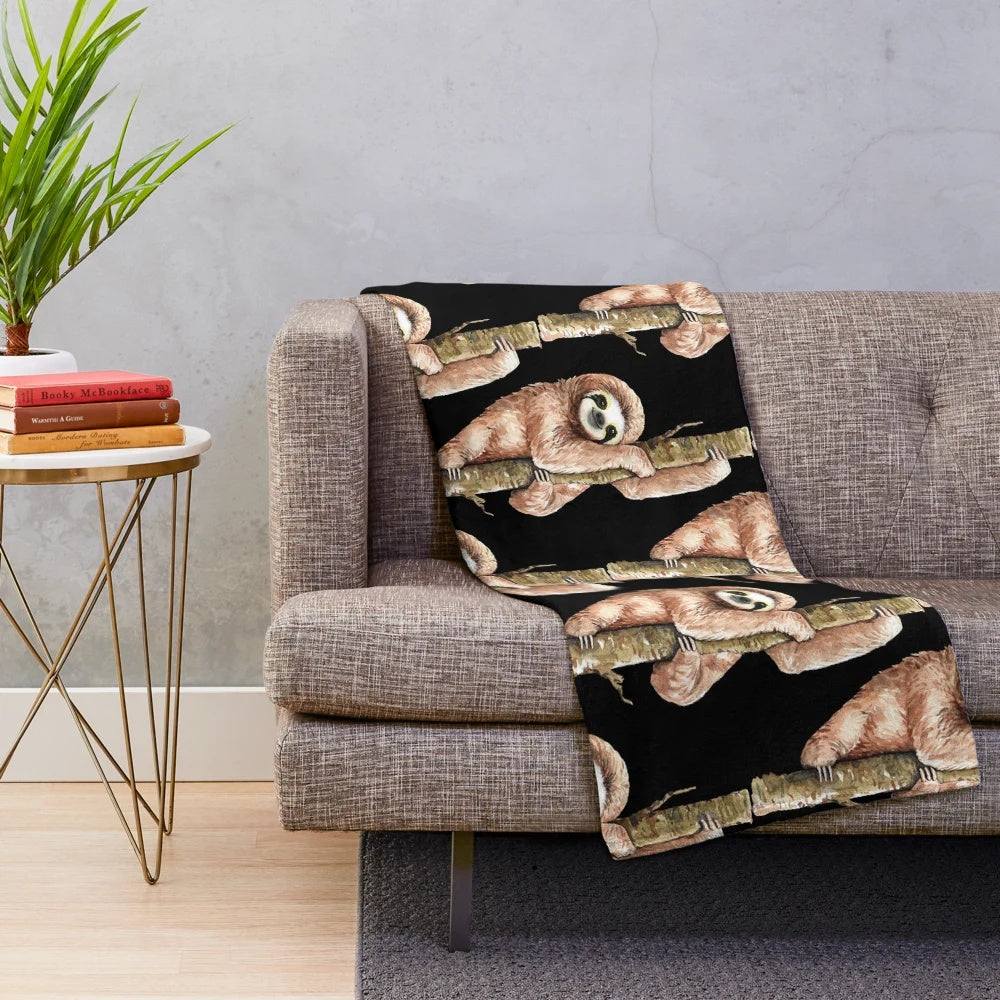 Soft and plush sloth-themed blanket with sloth sitting on a tree branch