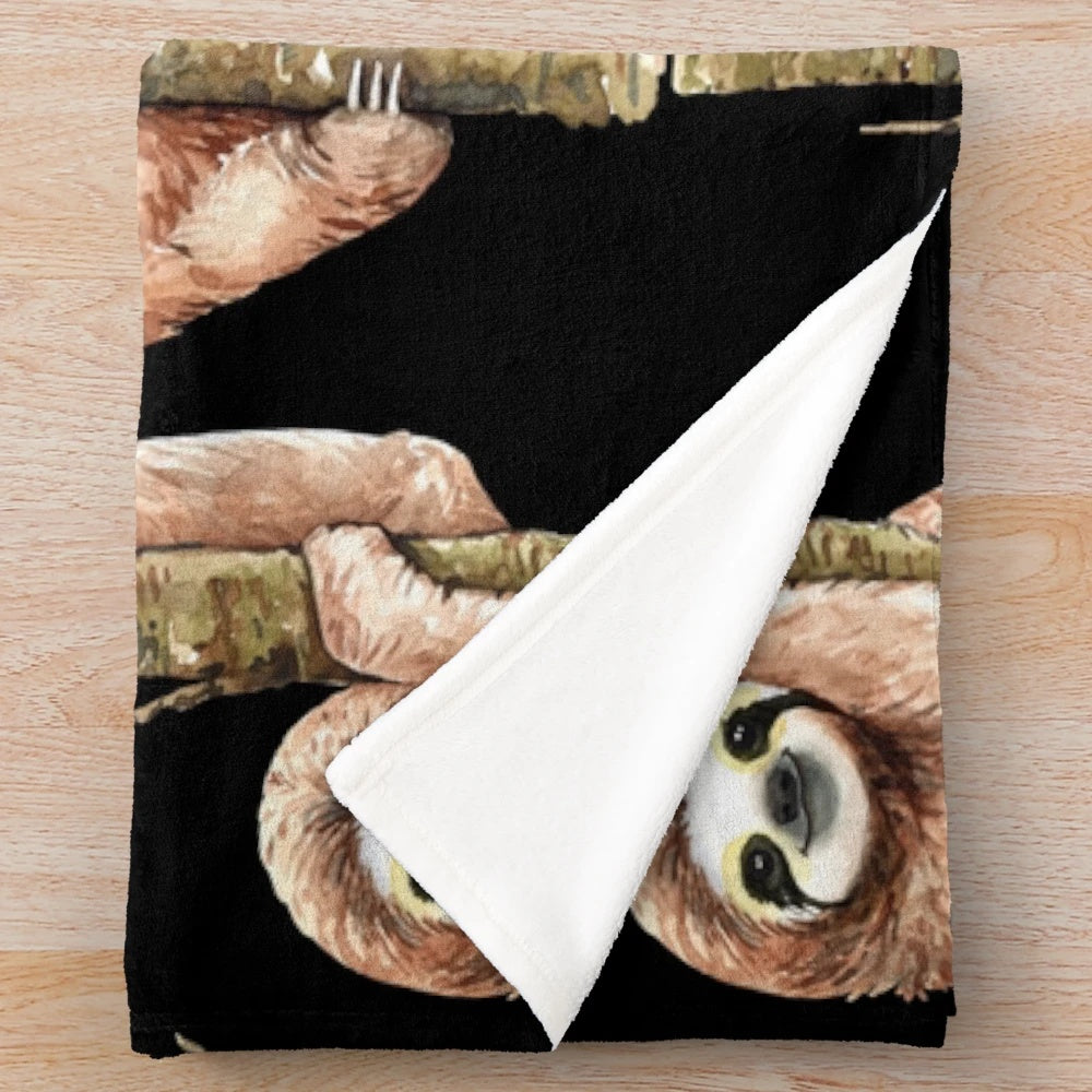 Soft and plush sloth-themed blanket with sloth sitting on a tree branch