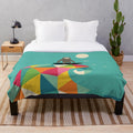 Colorful geometric patterned plush blanket with a surfing sloth design