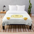Smiley plush blanket with a smiling emoji design