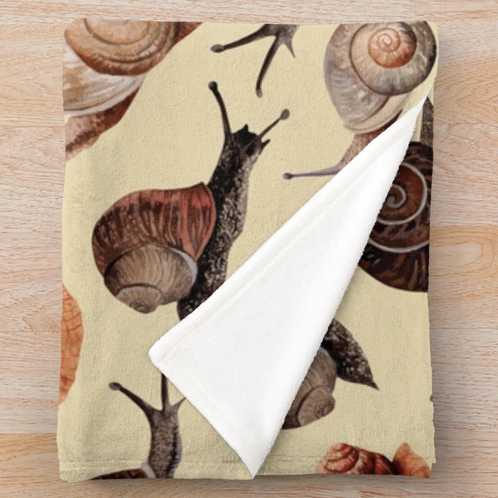 Snail plush blanket with shell and nature inspired design