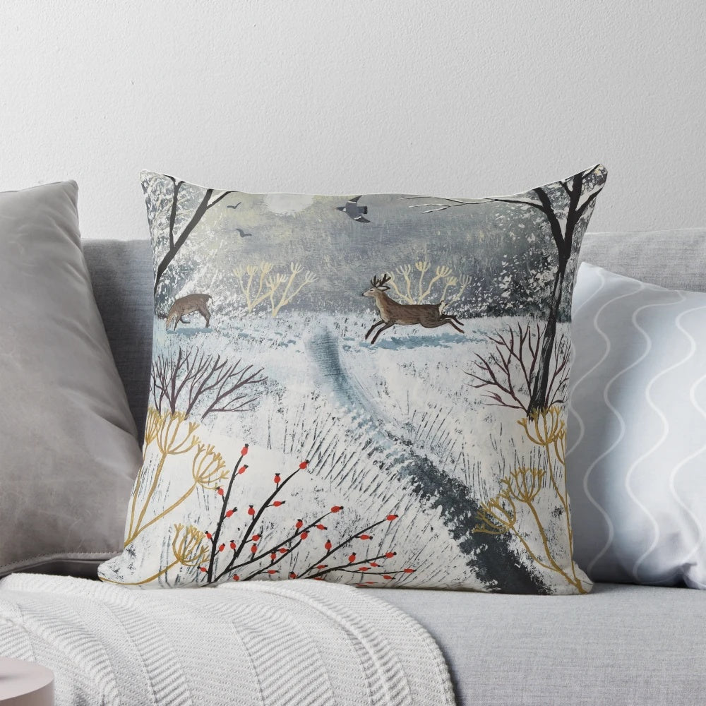 A soft, plush pillow featuring a peaceful snow scene with deer in a winter landscape.