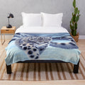 A cozy plush blanket featuring a beautiful snow leopard design by artist Roz Thompson