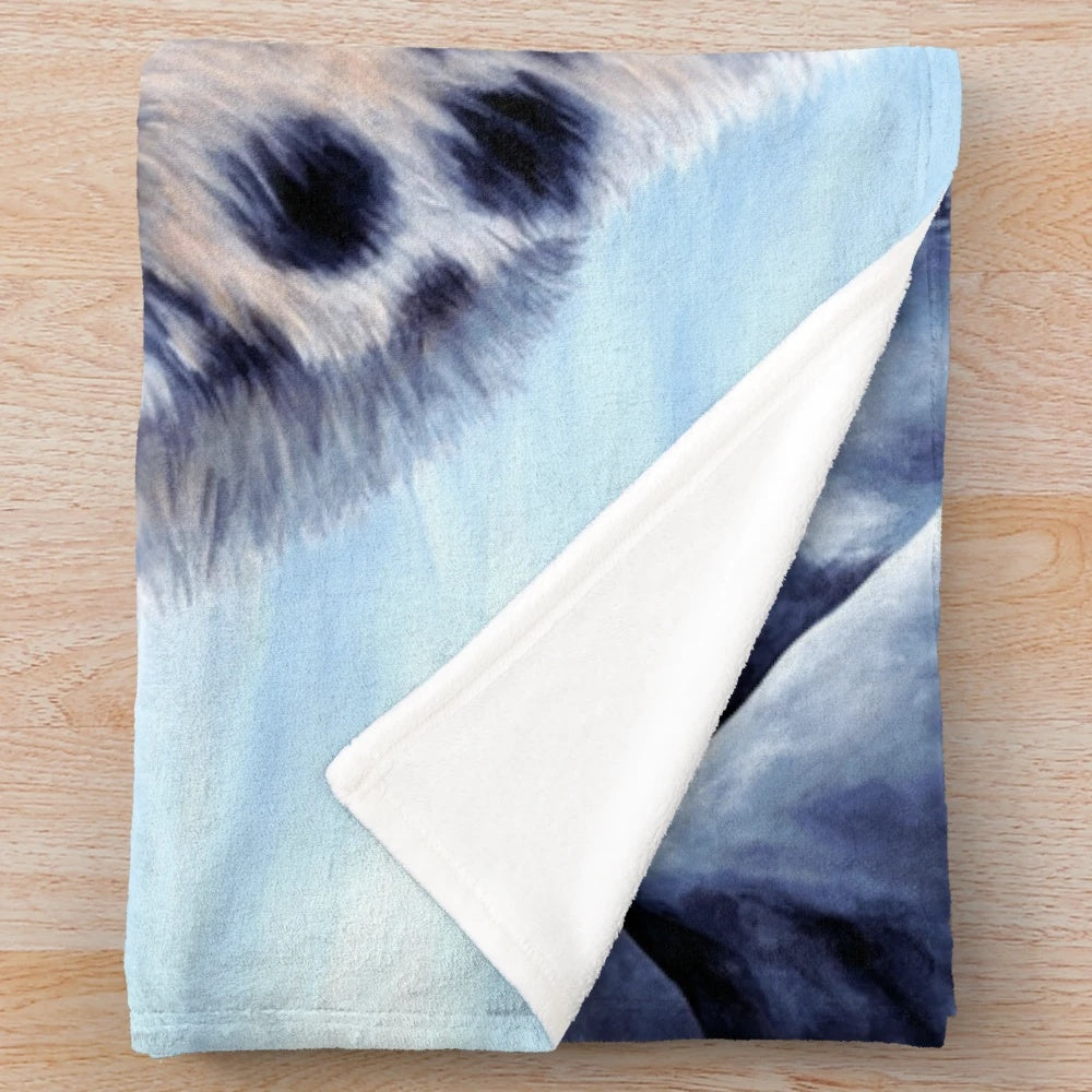 A cozy plush blanket featuring a beautiful snow leopard design by artist Roz Thompson