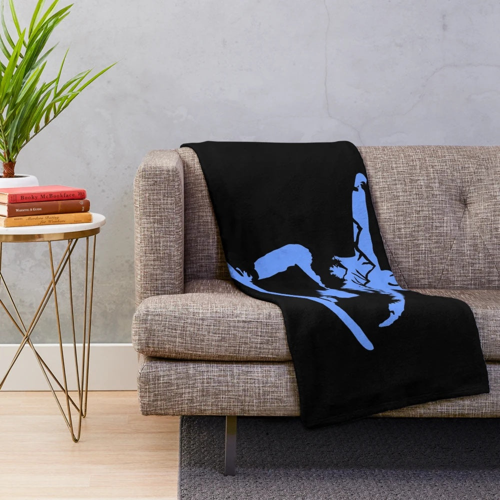Snowboarding silhouette on plush blanket with snowy mountains