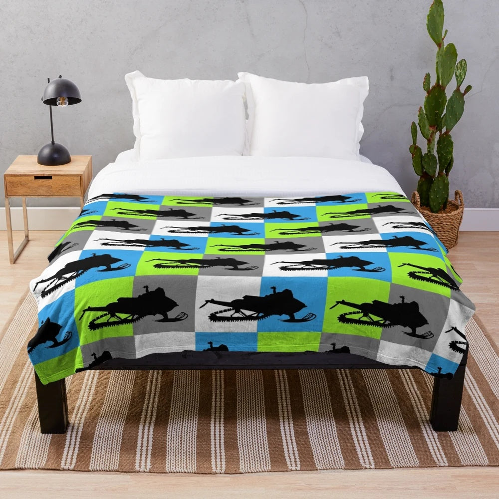 Snowmobile silhouette design on a colorful checkered pattern plush blanket