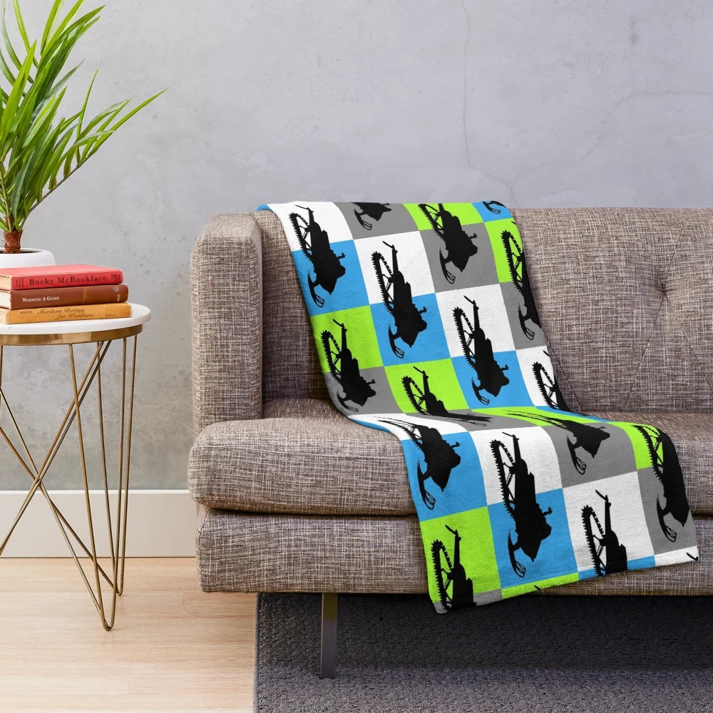 Snowmobile silhouette design on a colorful checkered pattern plush blanket