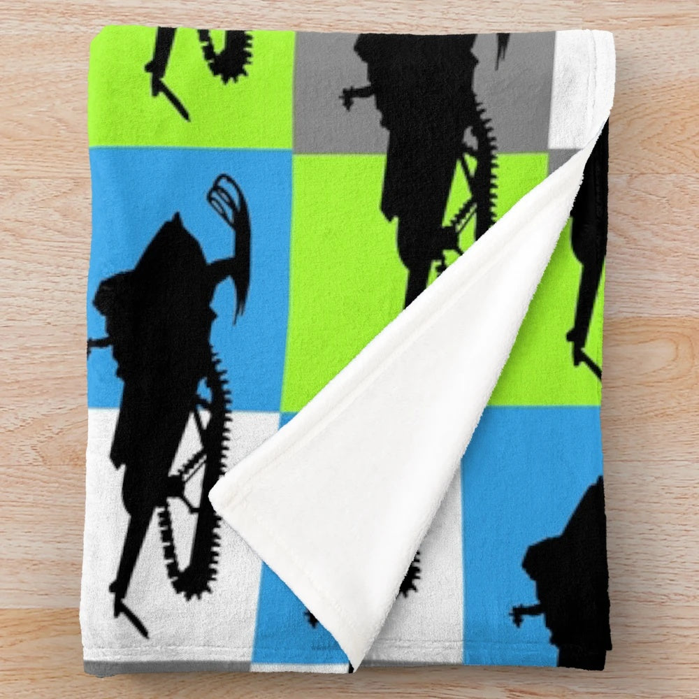Snowmobile silhouette design on a colorful checkered pattern plush blanket